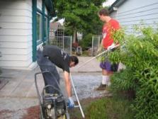 two installation techs lay out a corner sprinkler line